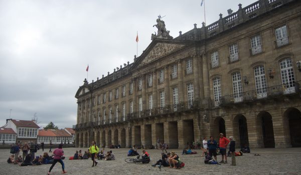 Cosa vedere nel centro storico di Santiago di Compostela: il Palazzo Raxoi, sede dell'Ayuntamiento, in Praza do Obradoiro che si riempie di pellegrini